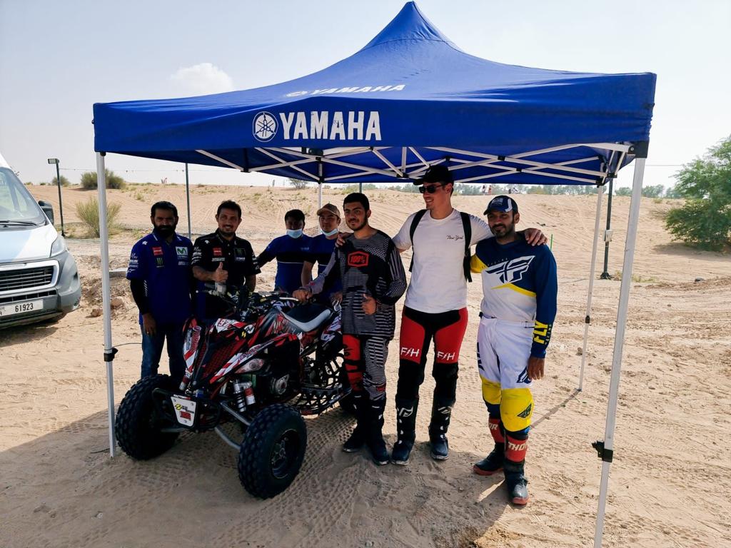 HR7 team at the dunes with a race ATV